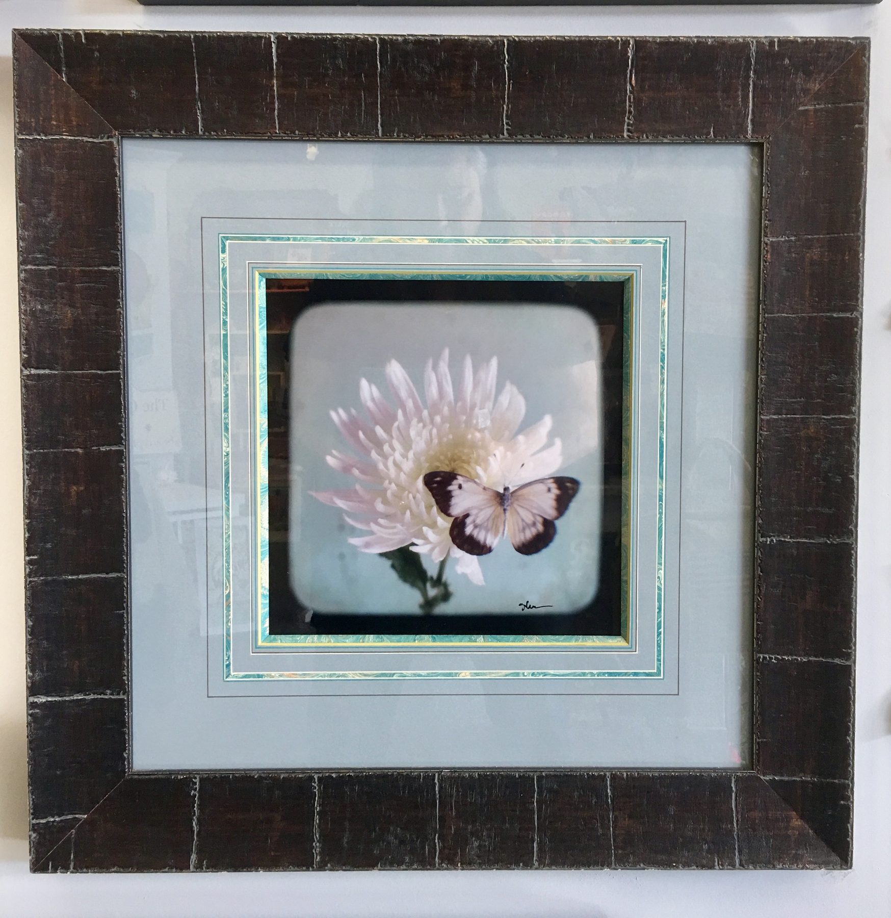 Butterfly piece in a dark mosaic frame