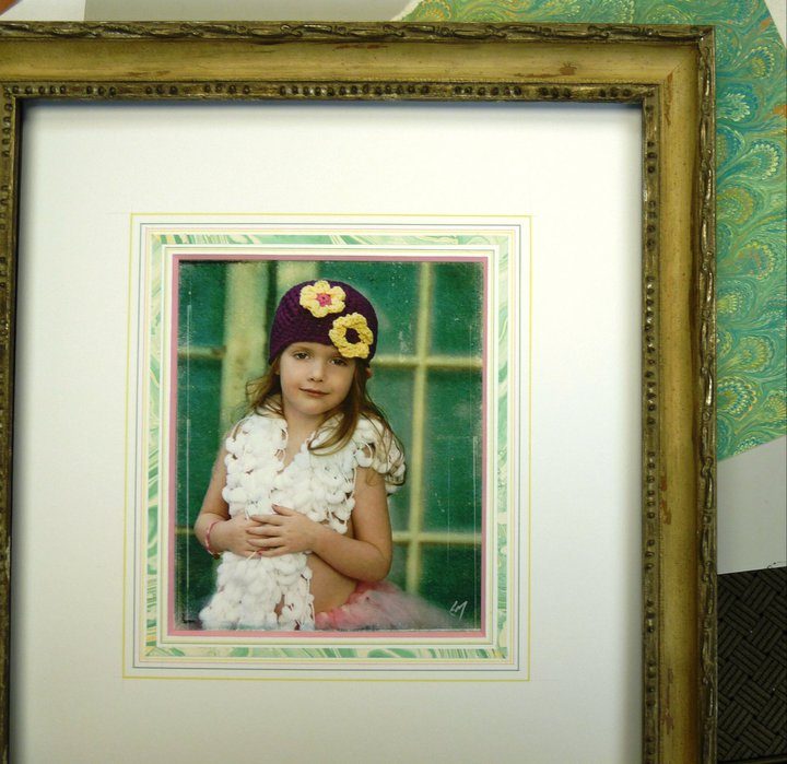 Child's portrait in a distressed green frame