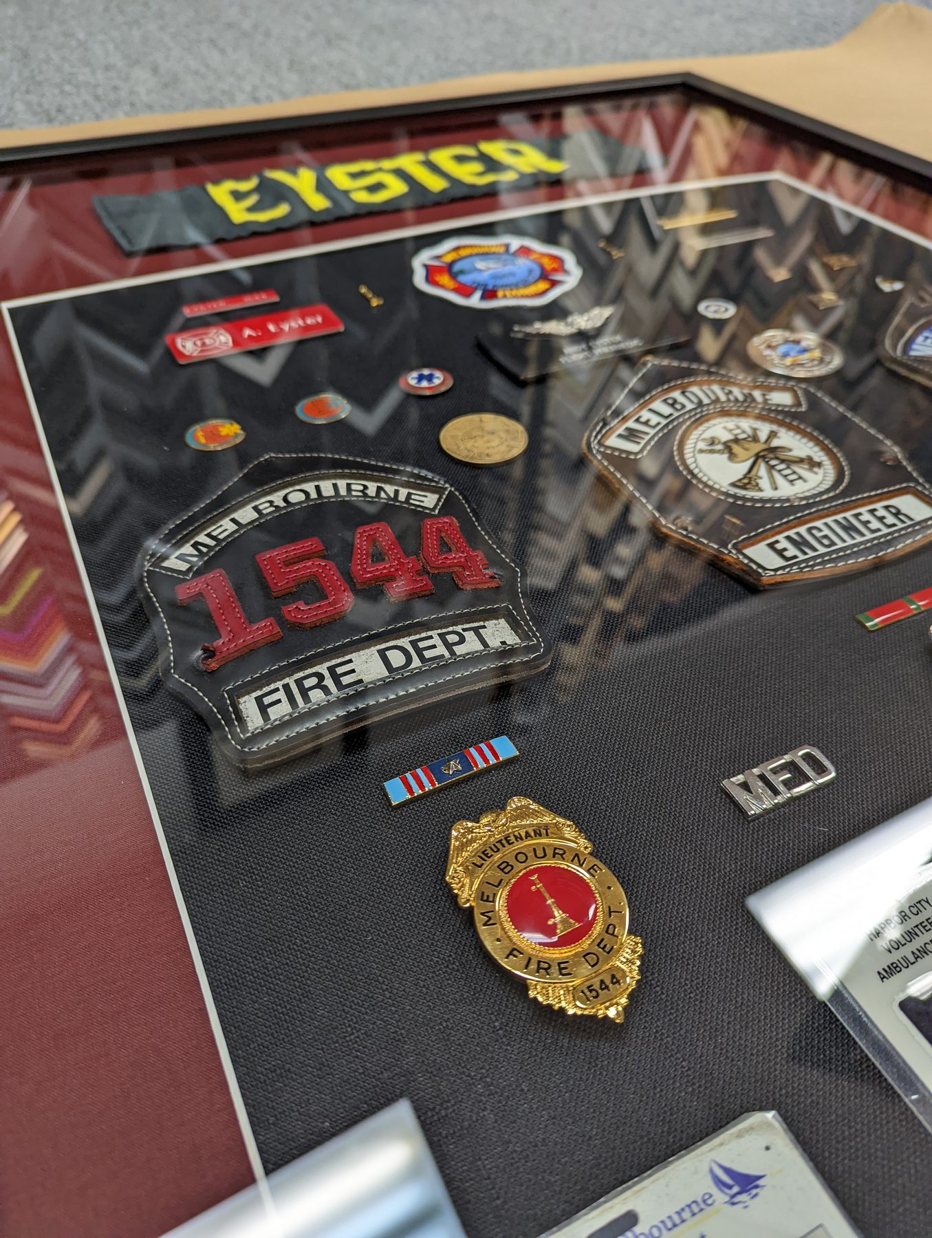 Firefighter memorabilia shadow box with badges and patches