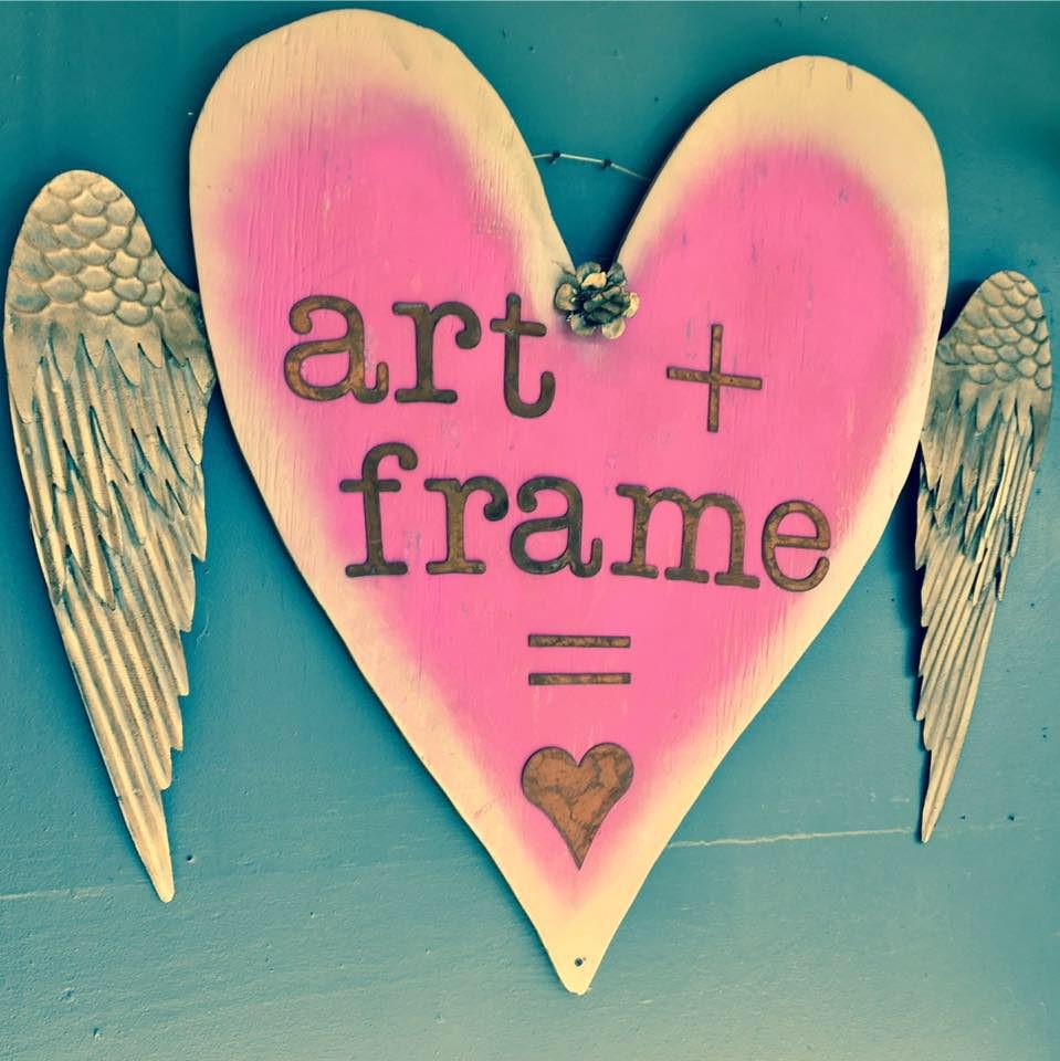 Hand-painted sign reading art plus frame equals love